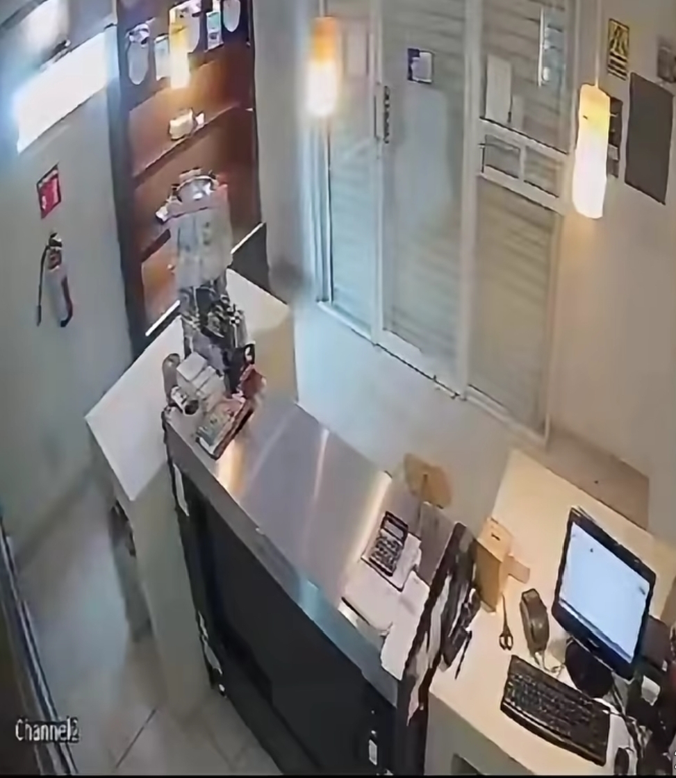 CCTV footage captures the moment an armed robber entered a store in South Africa, only for the quick-thinking salesgirl to lock him inside the shop.  